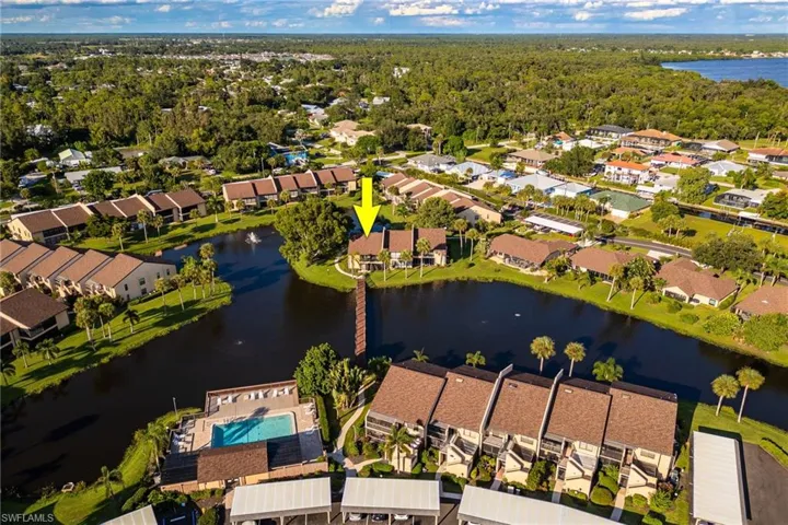 Aerial overview of property's location featuring a nearby body of water and nearby suburban area