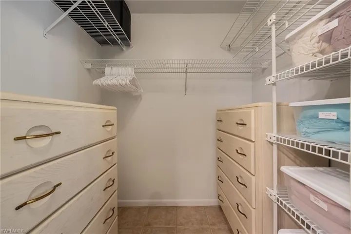 Spacious closet with light tile patterned floors