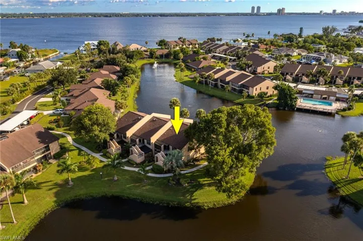 Aerial perspective of suburban area featuring a large body of water