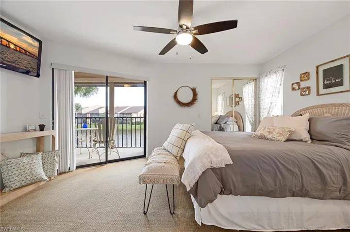 Carpeted bedroom with access to exterior, a closet, and a ceiling fan