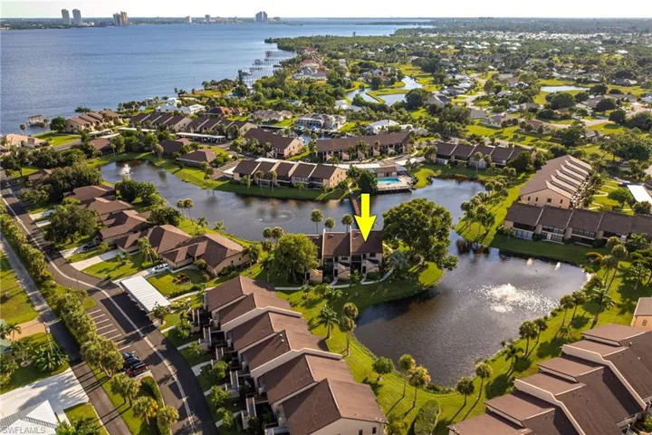 Aerial view of residential area featuring a nearby body of water