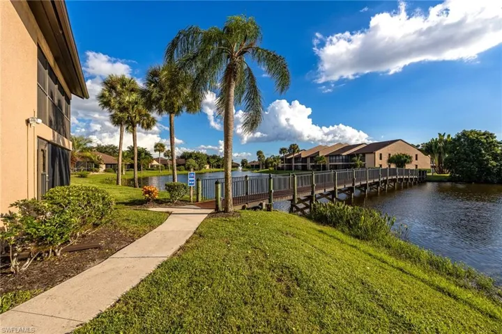 Surrounding community featuring a water view, a yard, and a residential view