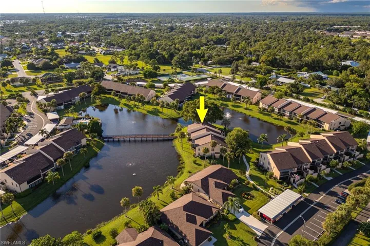 Aerial overview of property's location featuring a nearby body of water and nearby suburban area