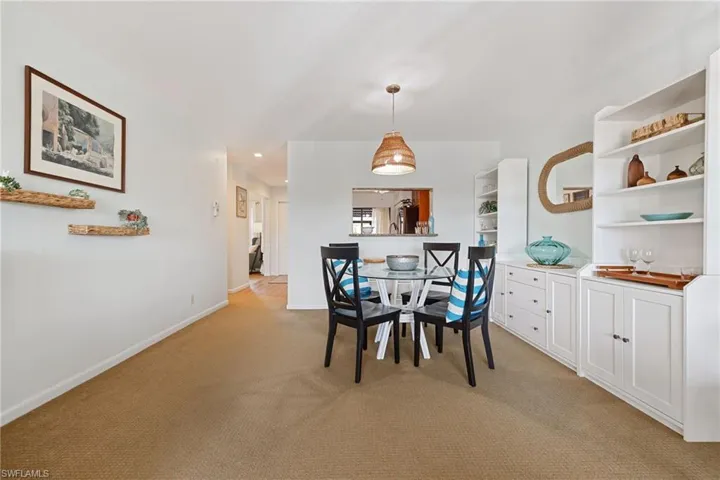 Dining space featuring light colored carpet and recessed lighting