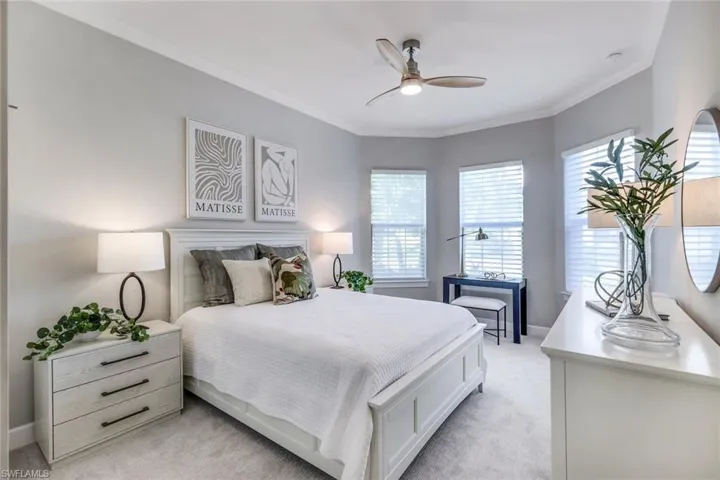 Bedroom featuring ornamental molding, ceiling fan, and light colored carpet