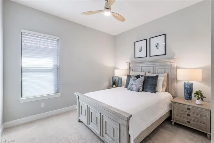 Carpeted bedroom with ceiling fan