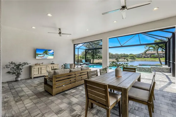 Dining room with a water view and ceiling fan