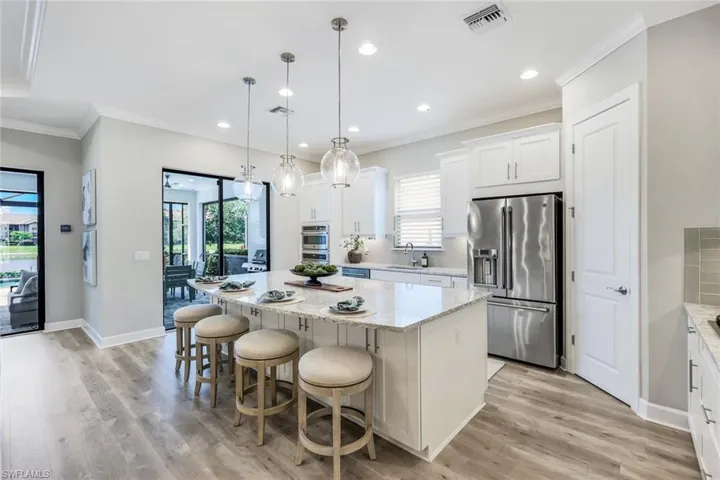 Kitchen featuring appliances with stainless steel finishes, light hardwood / wood-style floors, sink, and a kitchen island