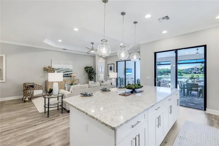 Kitchen featuring a center island, light hardwood / wood-style flooring, and white cabinetry