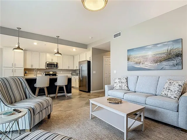 Living area featuring light tile patterned flooring and baseboards