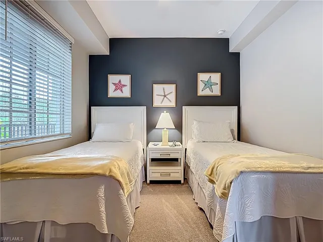 Bedroom with light colored carpet