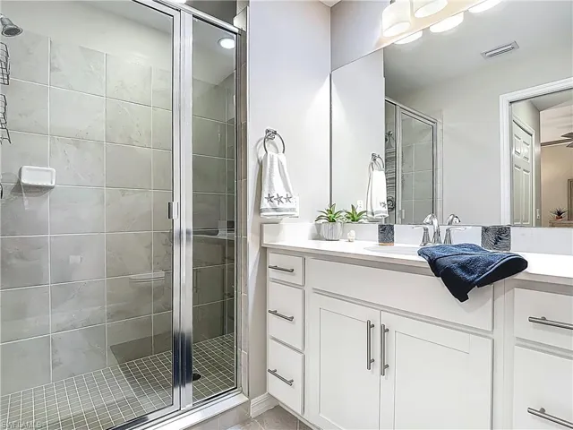 Full bathroom featuring a shower stall and vanity