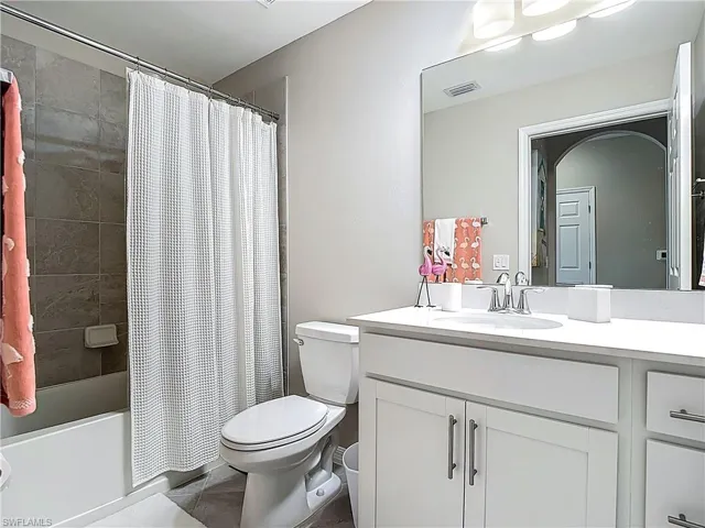Full bathroom featuring vanity and shower / bath combo with shower curtain