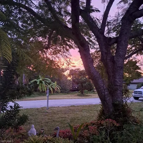Yard at dusk featuring a garage