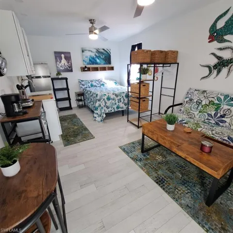 Bedroom with light hardwood / wood-style floors and ceiling fan