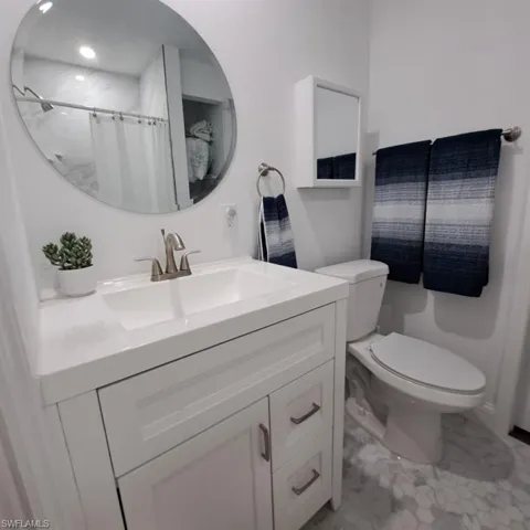 Bathroom with vanity, tile patterned flooring, and toilet