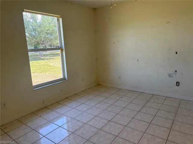 Spare room with plenty of natural light and light tile patterned floors