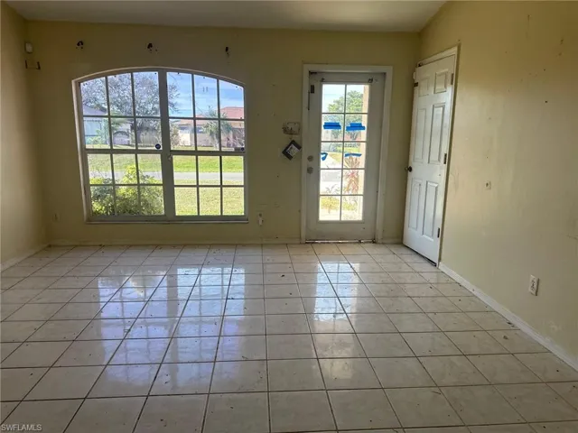Doorway to outside with light tile patterned flooring