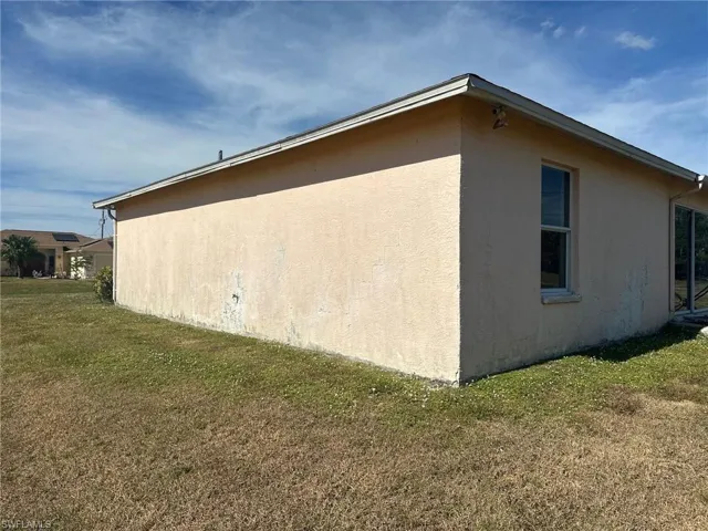 View of home's exterior with a yard