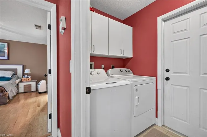 Dedicated laundry area with storage above, washer comes with the home but dryer does not.