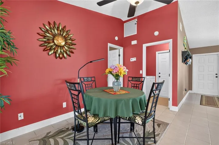 Dining area featuring a vaulted ceiling and tile flooring