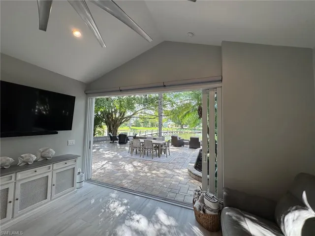 Doorway to outside featuring light hardwood / wood-style floors and lofted ceiling