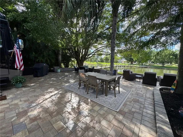View of patio / terrace with grilling area and a water view