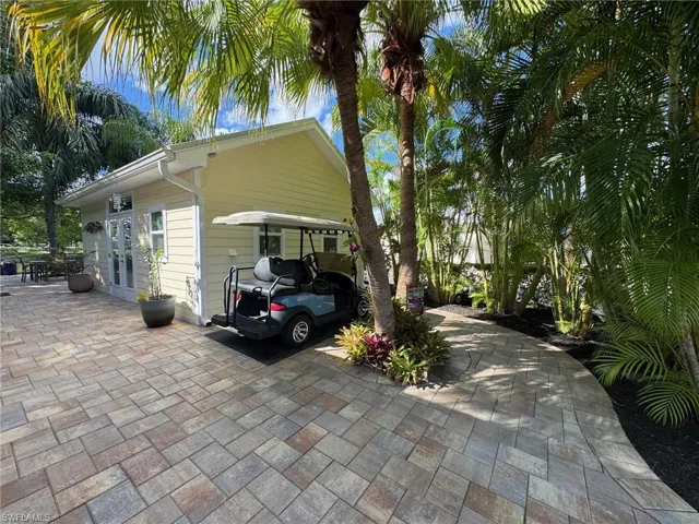 View of side of home with french doors and a carport