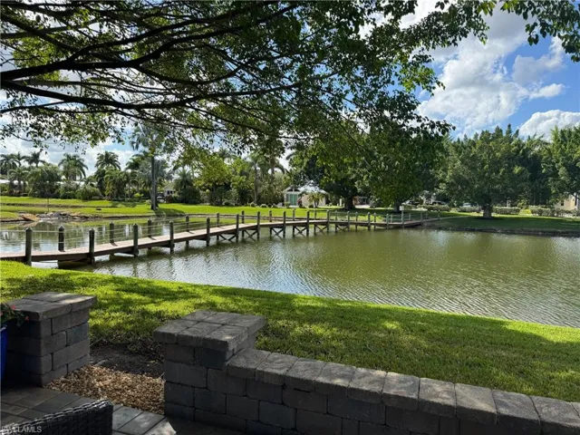 Dock area with a yard and a water view