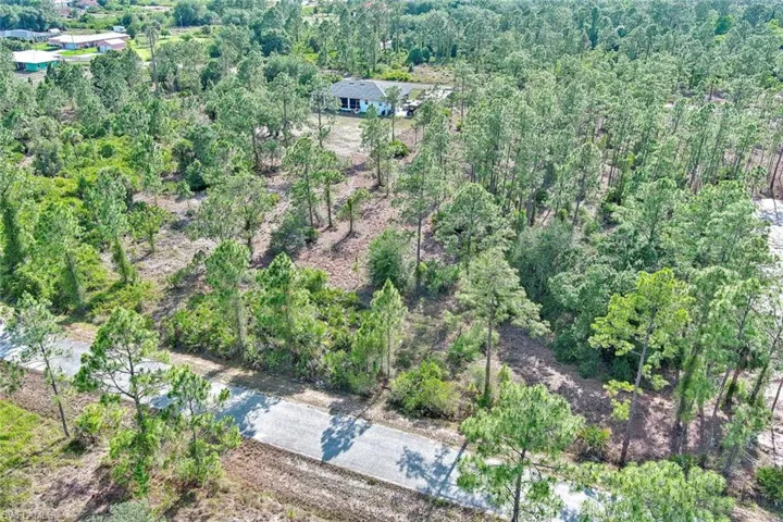 Aerial overview of property's location featuring a heavily wooded area