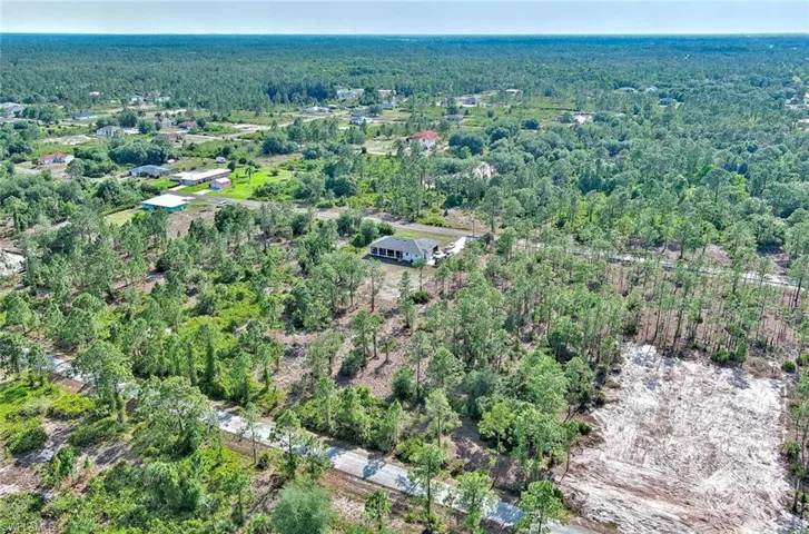 Aerial overview of property's location featuring a forest