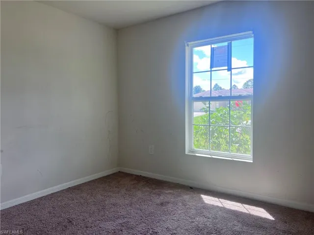 Empty room with carpet flooring