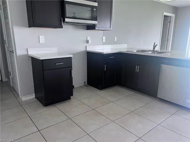 Kitchen with sink and light tile patterned floors