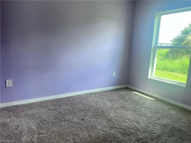 Carpeted spare room with a healthy amount of sunlight