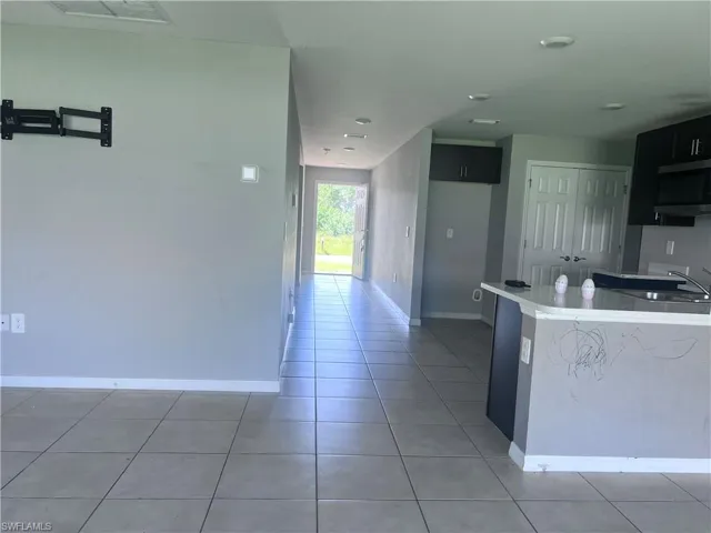 Kitchen with light tile patterned flooring and sink