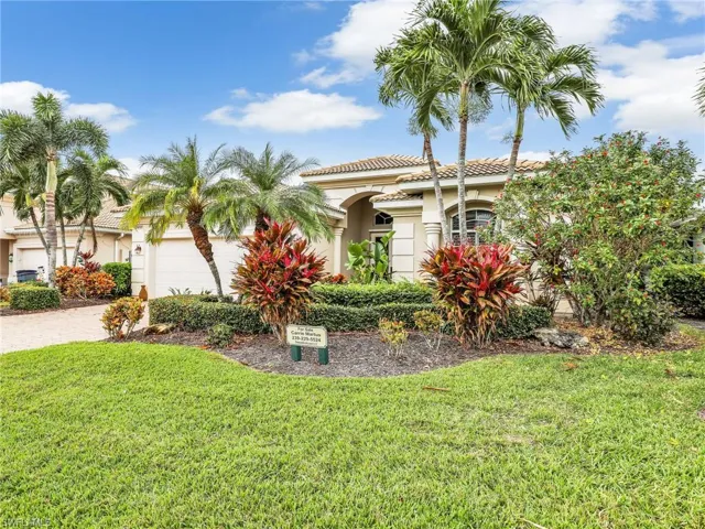 Mediterranean / spanish home with a garage and a front lawn