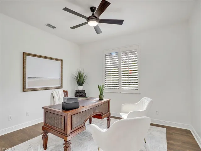 Office space featuring ceiling fan and wood-type flooring