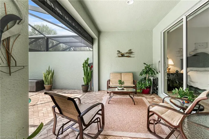DINING AREA WITH FAN W/ LIGHTING, COUNTERTOP BAR AREA, LIVING ROOM & HUGE LANAI=THIS HOME HAS THE ROOM TO ENTERTAIN ALL YOUR FAMILY & FRIENDS!