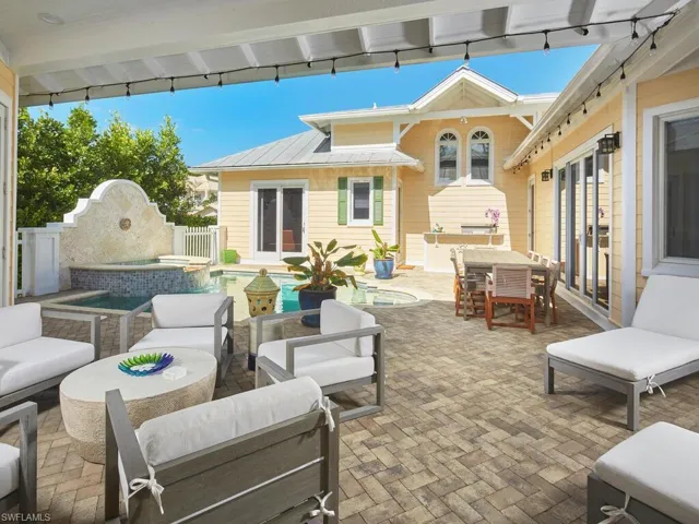 View of patio / terrace featuring an outdoor living space, a pool with connected hot tub, and outdoor dining area