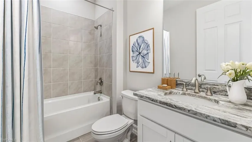 This image is virtually staged. Bathroom with vanity and shower / tub combo with curtain
