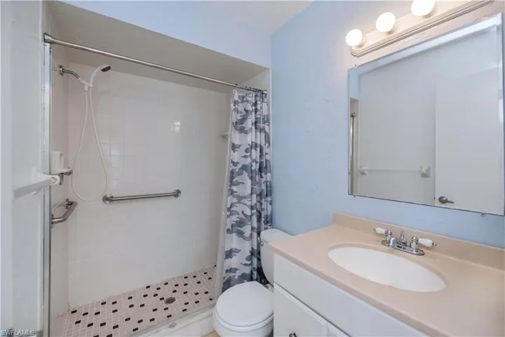Full bath featuring vanity and a stall shower