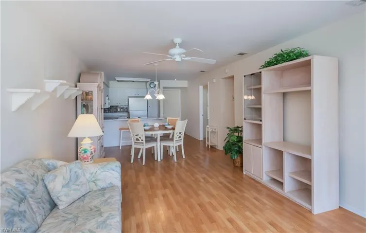 Living room with light wood-style floors and ceiling fan