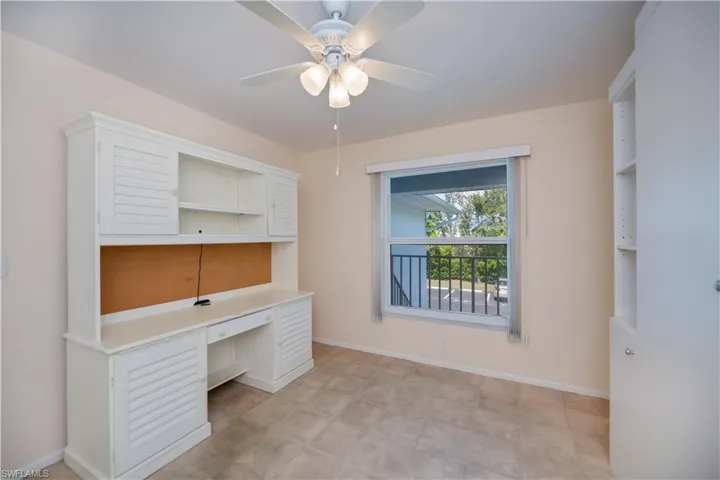 Unfurnished office featuring built in study area and ceiling fan