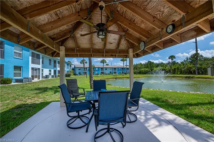 View of patio featuring a water view, outdoor dining area, and a ceiling fan