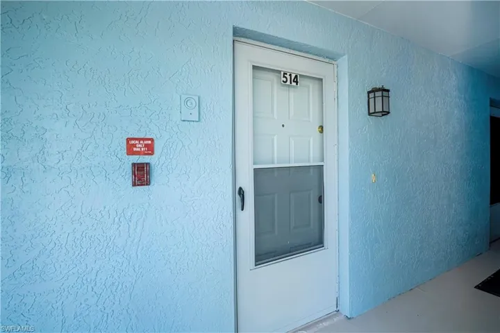 Property entrance featuring stucco siding