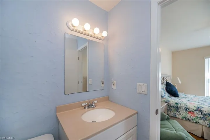 Ensuite bathroom with a textured wall and vanity