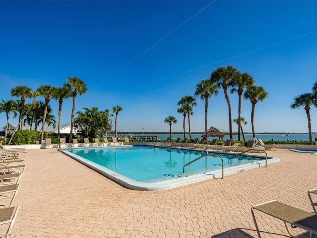 View of pool featuring a patio and a water view
