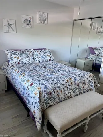 Bedroom featuring wood finished floors and a closet