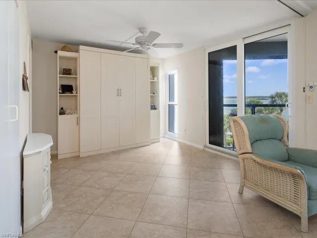 Entrance foyer featuring light tile patterned floors and ceiling fan