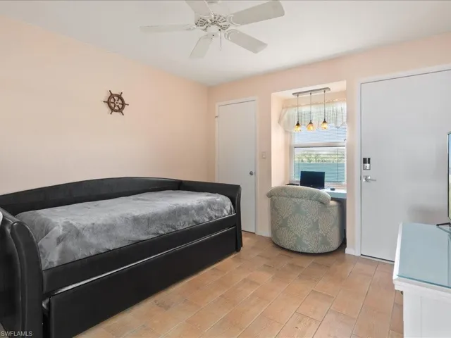 Bedroom with ceiling fan and light hardwood / wood-style flooring